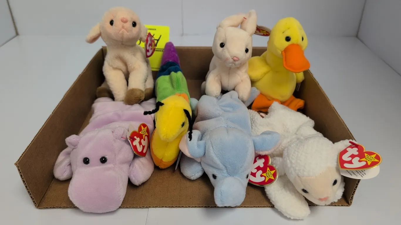 A Collection of Ty Beanie Babies Plush Toys. (Ty, 1990s) A set of seven assorted animal Beanie Babies, including a rabbit (Nibbler), duck, lambs, elep