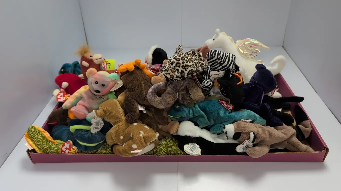 A Collection of Ty Beanie Babies. (Ty, 1990s) An assortment of plush animal figures including Princess Bear, Peace Bear, Scorch, and Bongo, each featu