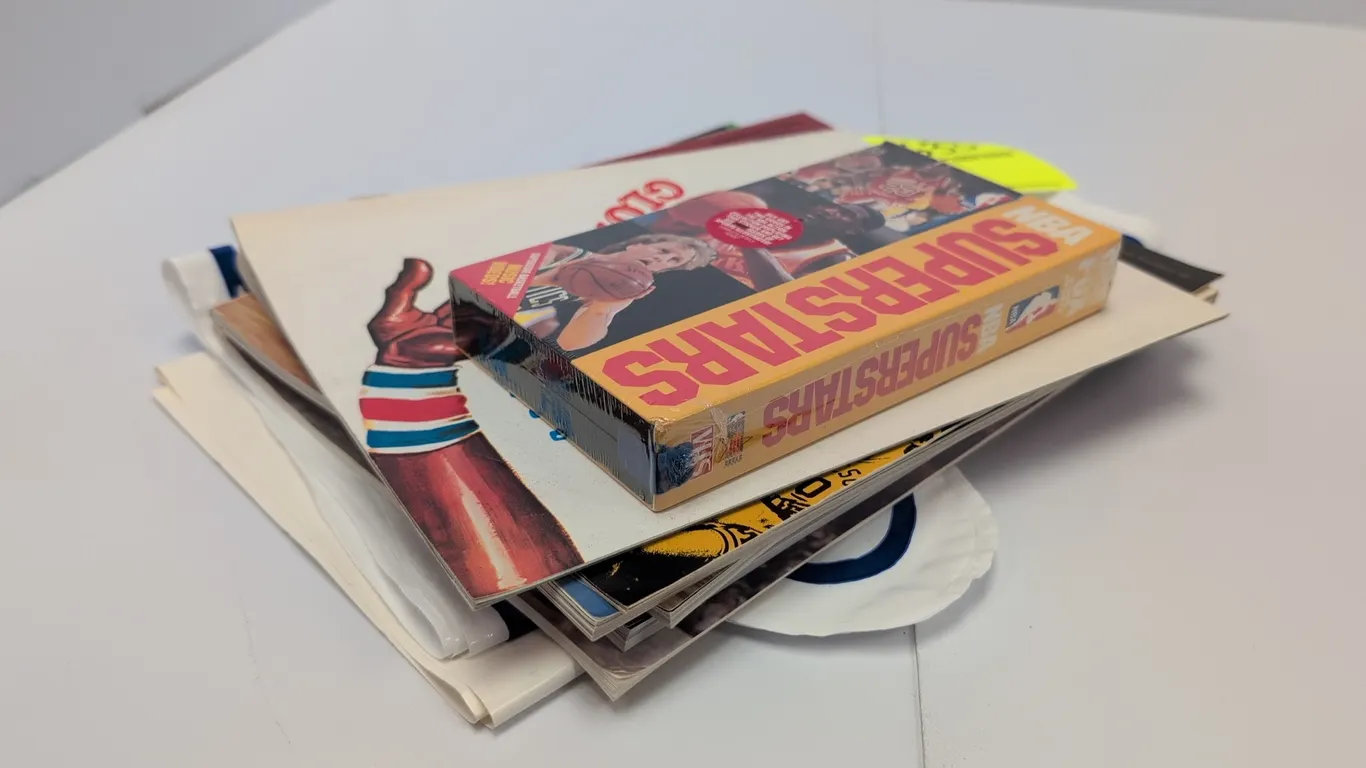 A Collection of Vintage Basketball Memorabilia. (Various, 1976-1992) Includes a factory-sealed "NBA Superstars" VHS tape, vintage programs (1977 Harle