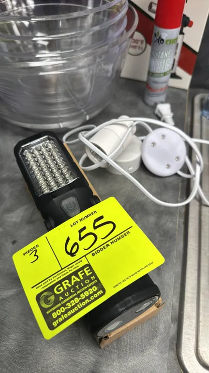 Assorted lights. Includes (1) portable LED work light featuring a front LED array, integrated power button, folding stand, and dual magnetic base, and