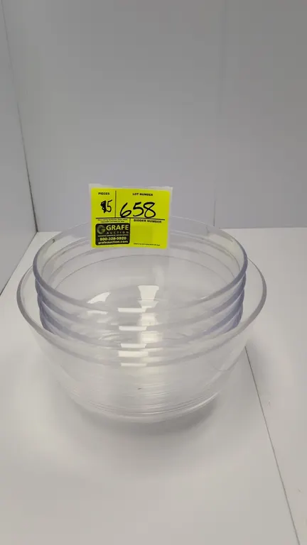 Assorted clear plastic mixing bowls. Features durable clear polymer construction in assorted sizes, including nested bowls with ribbed exterior detail