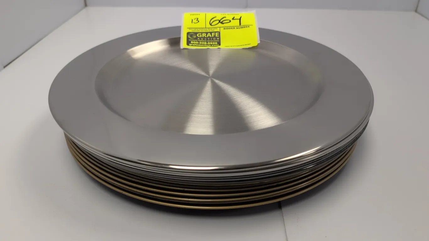 Assorted metal and poly platters. Includes silver-tone metal platters and gold-tone charger plates featuring beaded rim detailing. Dimensions: 13" dia