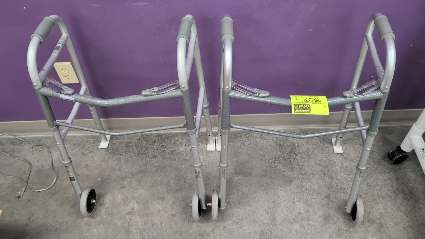 Guardian G30756P folding walkers. Features lightweight aluminum frame construction, front wheels, rear glide feet, textured hand grips, folding mechan
