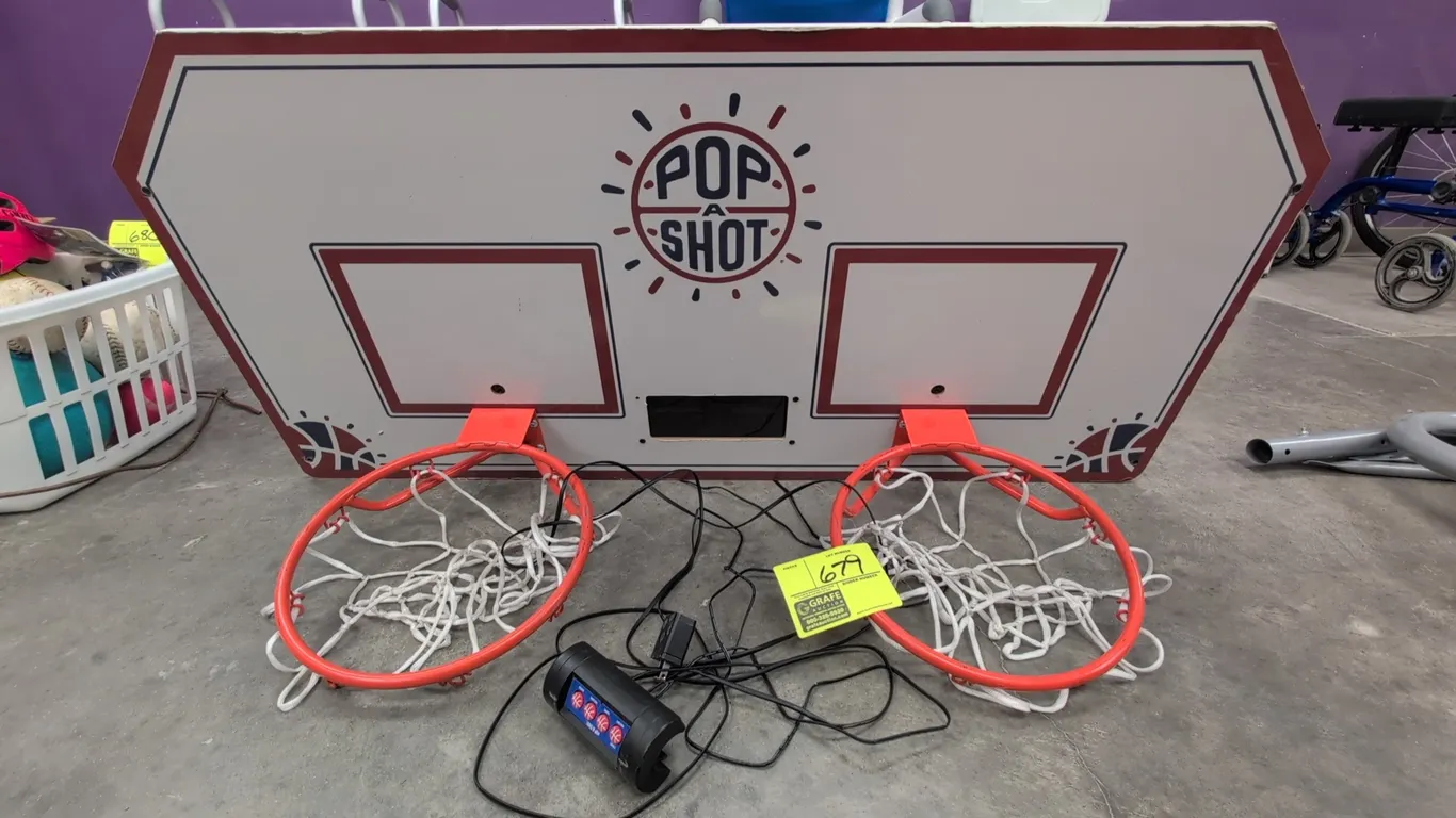 Pop A Shot dual hoop basketball backboard. Features (2) orange rims with nets, wired control pad, power adapter, and electronic sensors. 46"W. Note: F