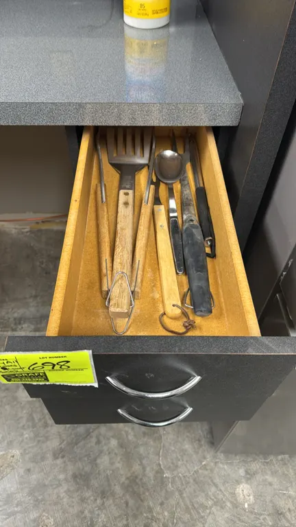 Assorted kitchen smallwares. Includes stainless steel flatware with an organizer tray, grilling tools, cooking utensils, pizza cutter, utility scoops,