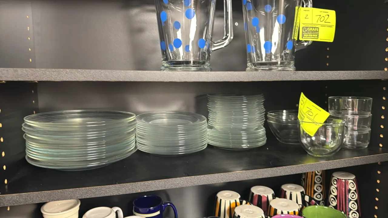 Clear glass dinnerware and dishware assortment. Includes assorted plates, saucers, tapered glass bowls, small prep bowls, and a handled glass mug. She
