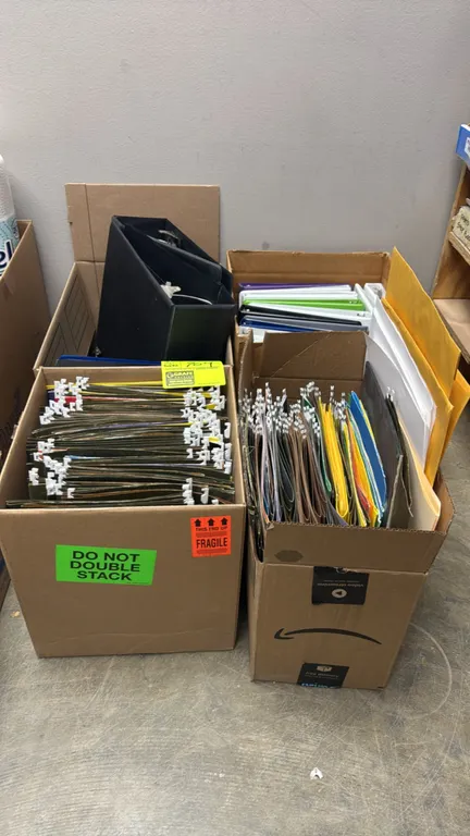 Assorted office supplies across (4) boxes. Includes 3-ring binders, lever-arch binders, hanging file folders with index tabs, manila envelopes, labels