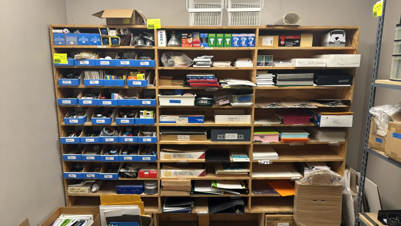 Assorted office and facility supplies. Includes light bulbs, Johnson & Johnson first aid kit, manual soap dispenser, clipboards, binders, envelopes, f