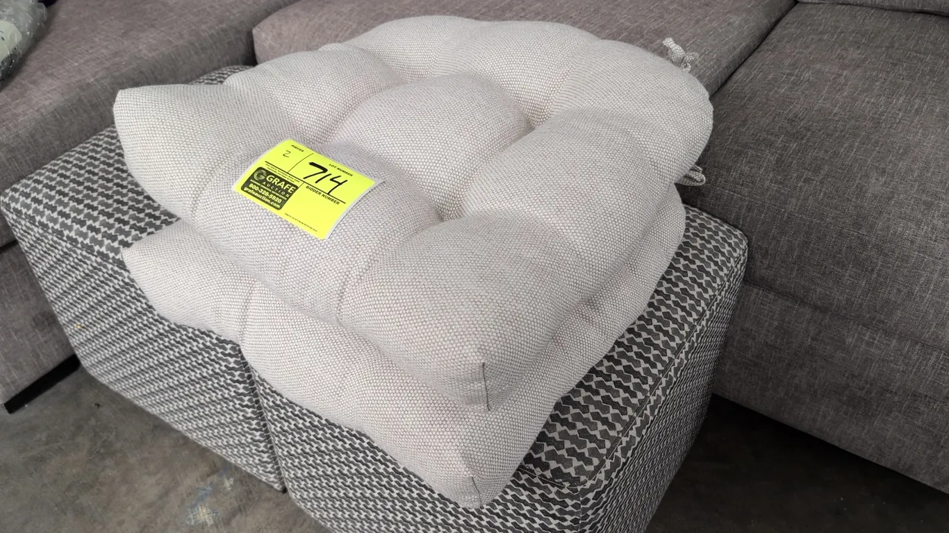 Cloth chair cushions. Features tufted design, woven textured fabric upholstery in a neutral tone, and corner tie attachments. 20". Furniture in backgr