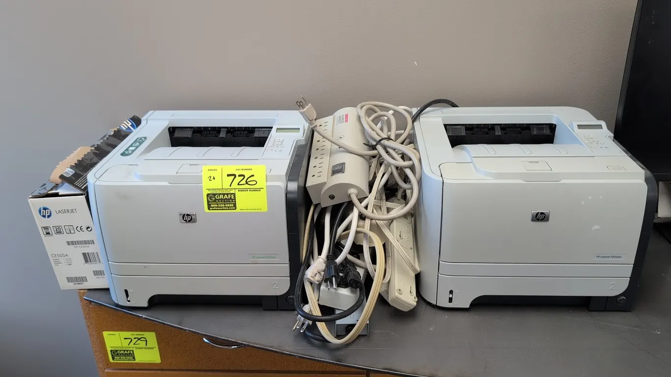 HP LaserJet P2055dn laser printers. Includes HP 05A toner cartridge, surge protectors, and power cables.