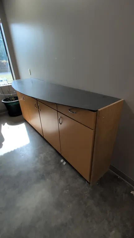 Cabinet with metal top. Features wood composite base construction, 4 drawers, and 4 lower storage cabinet doors with chrome-tone pulls. 86"L. Contents