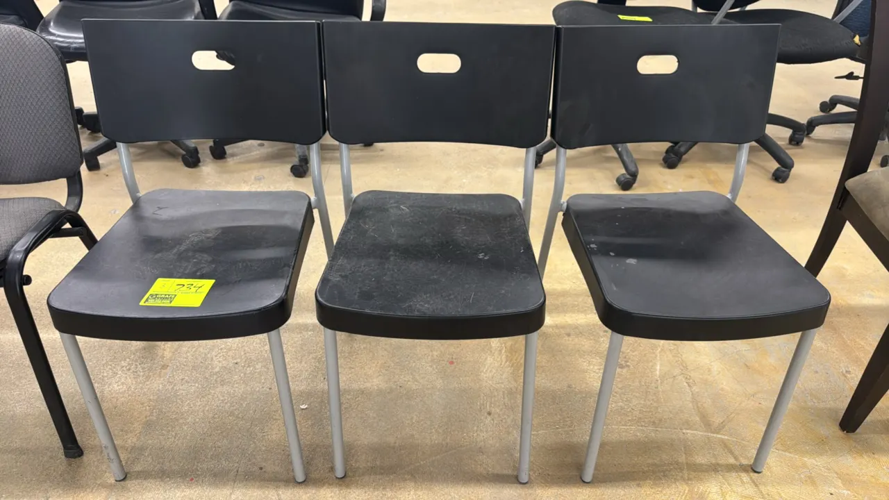 Polypropylene side chairs. Features black molded poly seats and backrests with integrated handle cutouts. Mounted on silver-tone tubular metal 4-leg f