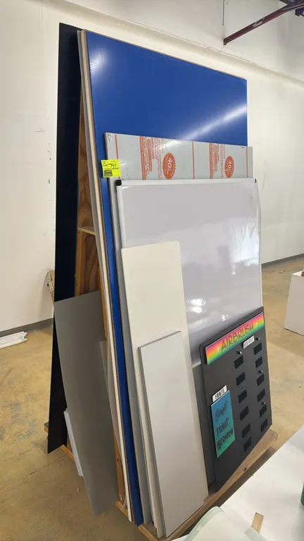 Wood A-frame portable sheet material rack. Features double-sided vertical storage and internal shelving. Includes various foam board, acrylic sheets,