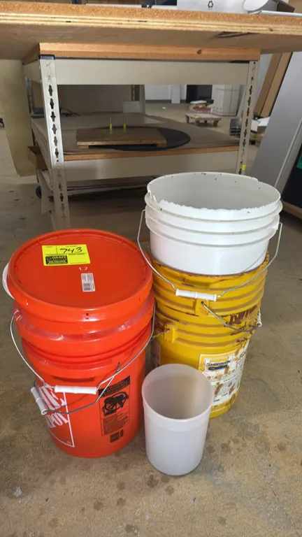 Bulk lot of assorted plastic buckets. Includes 5-gallon style buckets in orange, yellow, and white with wire bail handles, one snap-on lid, and a smal