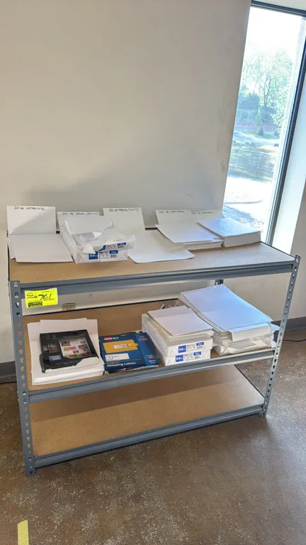 Metal 3-tier shelving rack with assorted paper stock. Features particle board shelf decking and steel frame. Includes various paper stock including le