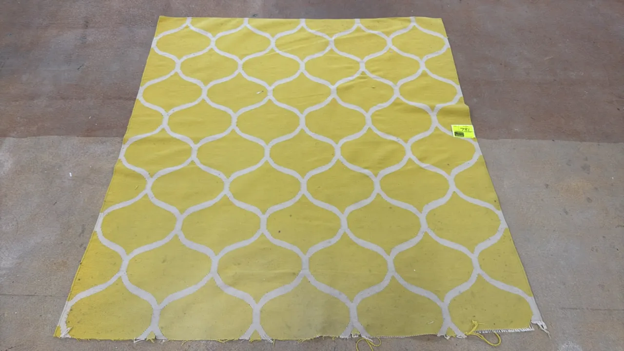Area rug featuring a yellow and white geometric trellis pattern. Dimensions: 72" x 74". Note: One edge is frayed and unraveled.