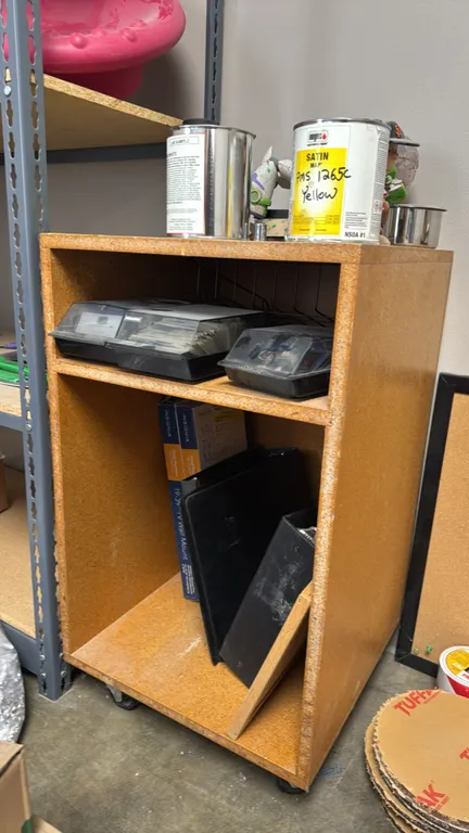 Wood portable cabinet. Features two open storage compartments. Dimensions: 18" x 18" x 31". Mounted on casters. Contents not included.