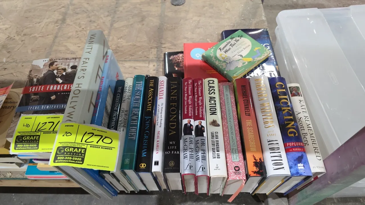 Assorted hardcover books. Includes titles across fiction, non-fiction, biography, and wellness by authors including John Grisham, Jane Fonda, Barbara