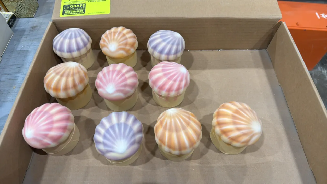 A Set of (10) Custom Molded Shells. Features ten custom molded decorative seashell pieces with scallop shell tops in assorted pastel shades of pink, p