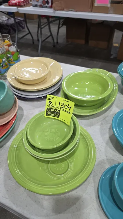 A Homer Laughlin Fiesta Seven-Piece Dishware Set. (Homer Laughlin, 1998) A seven-piece ceramic dishware set in green glaze featuring signature concent