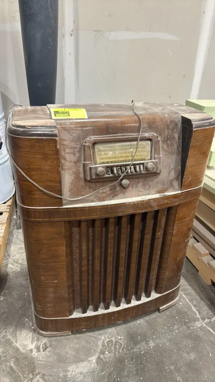 Coronado C 800 vintage console tube radio. Features wood cabinet with vertical grille louvers, multi-band analog dial, push-button station presets, in