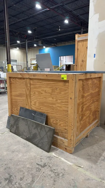 Wood shipping crate. Features plywood and dimensional lumber framed construction with an integrated skid base for forklift handling. Dimensions: 55" x