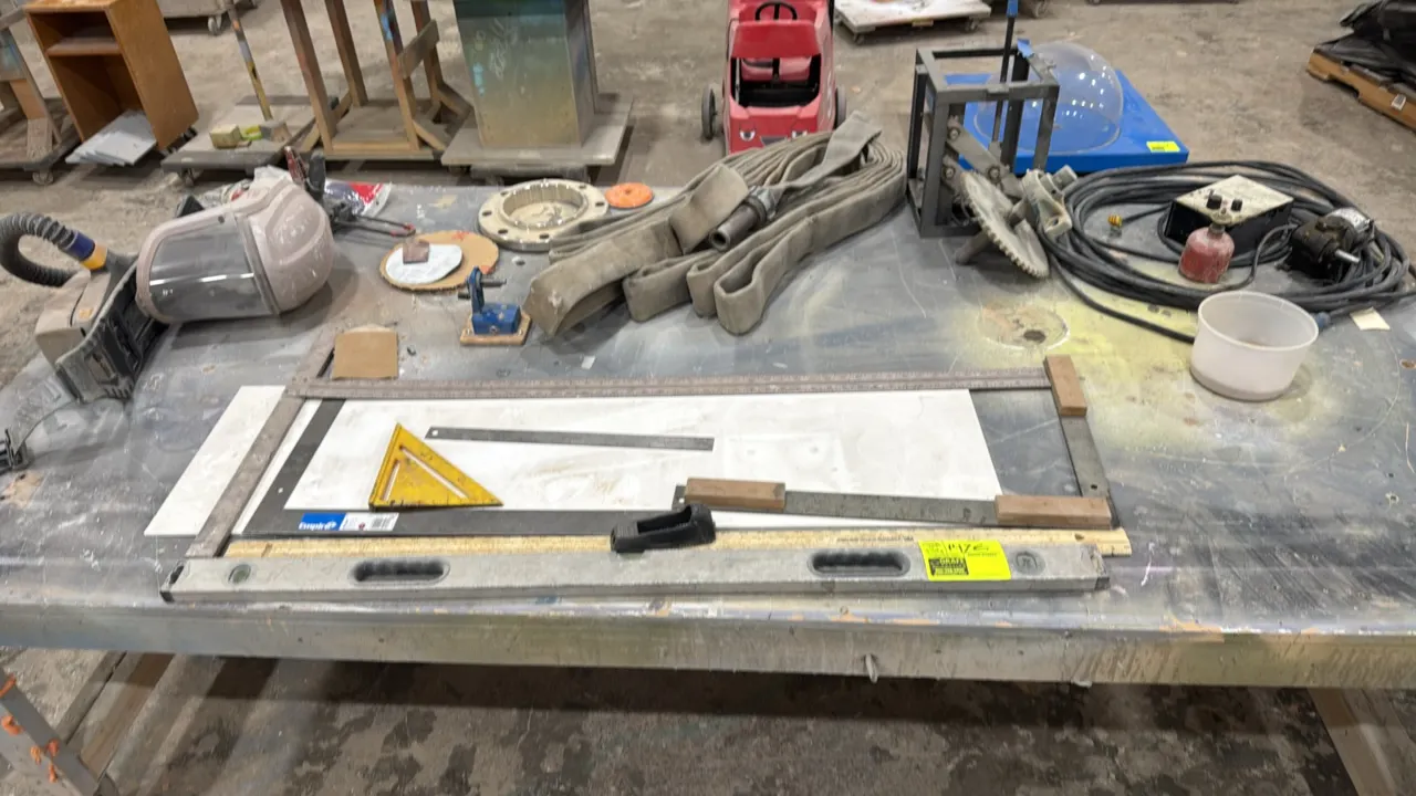 Package lot of shop tools, layout tools, and equipment. Includes aluminum level, framing square, speed square, flat discharge hose, adhesive applicato