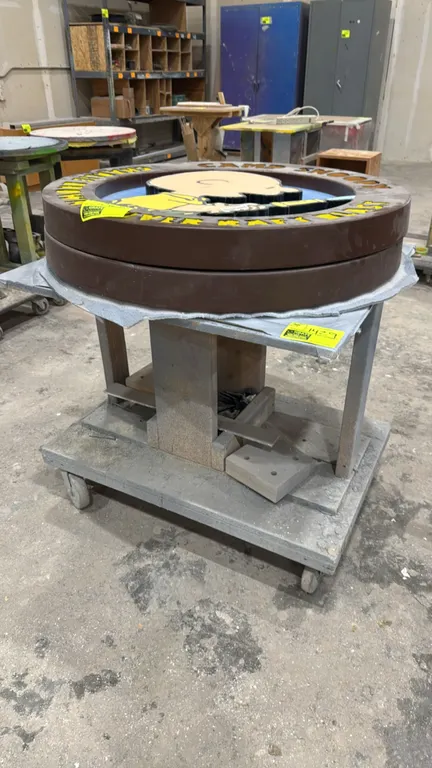 Custom portable wood workbench. Features solid wood construction with an elevated work surface and lower base platform. 36" x 25". Mounted on casters.