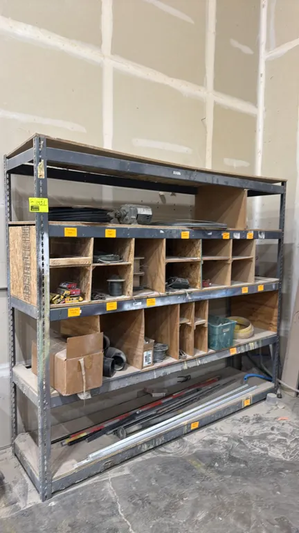 Metal 5-tier shelving rack. Features wood decking, custom wooden cubby/bin dividers, and assorted contents including a small electric motor, wire spoo