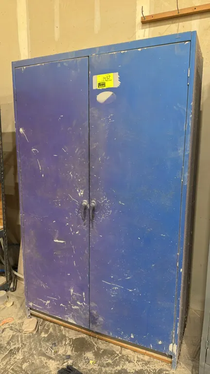 Metal 2-door storage cabinet. Features dual solid swing doors with handles, blue exterior finish, and adjustable interior shelves. 4'W.