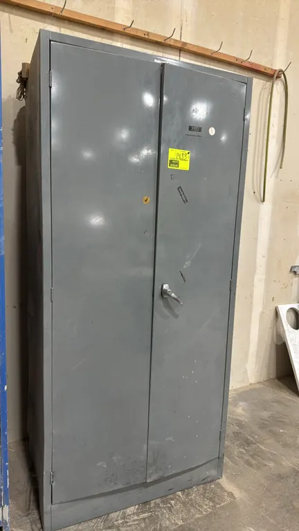 Hallowell metal 2-door storage cabinet. Features double doors with latching handle, custom interior wooden shelving, and organizer compartments. 3'W.