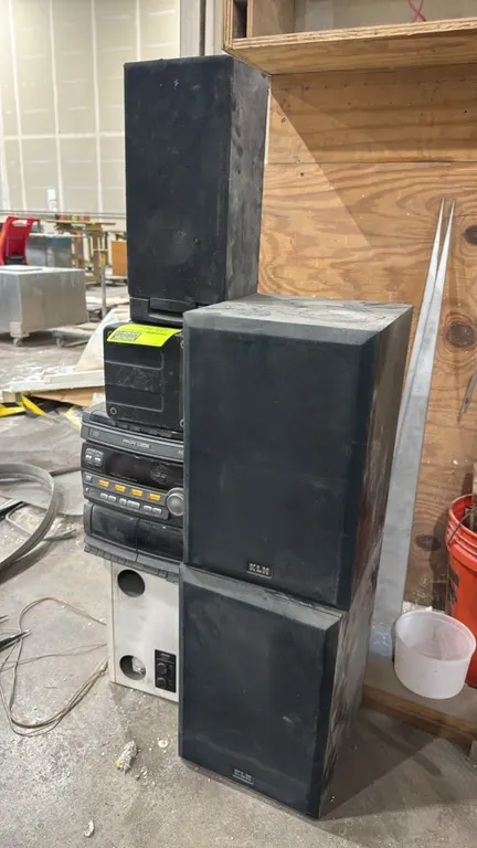Philips Magnavox FW316C mini Hi-Fi stereo system with assorted speakers. Features a 3-disc CD changer, dual cassette deck, and digital AM/FM tuner. In