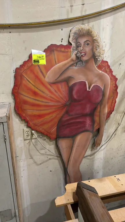 A Custom Marilyn Monroe-Style Pin-Up Cutout Art Piece. Features a painted depiction of a blonde pin-up figure in a red corset against an umbrella fan