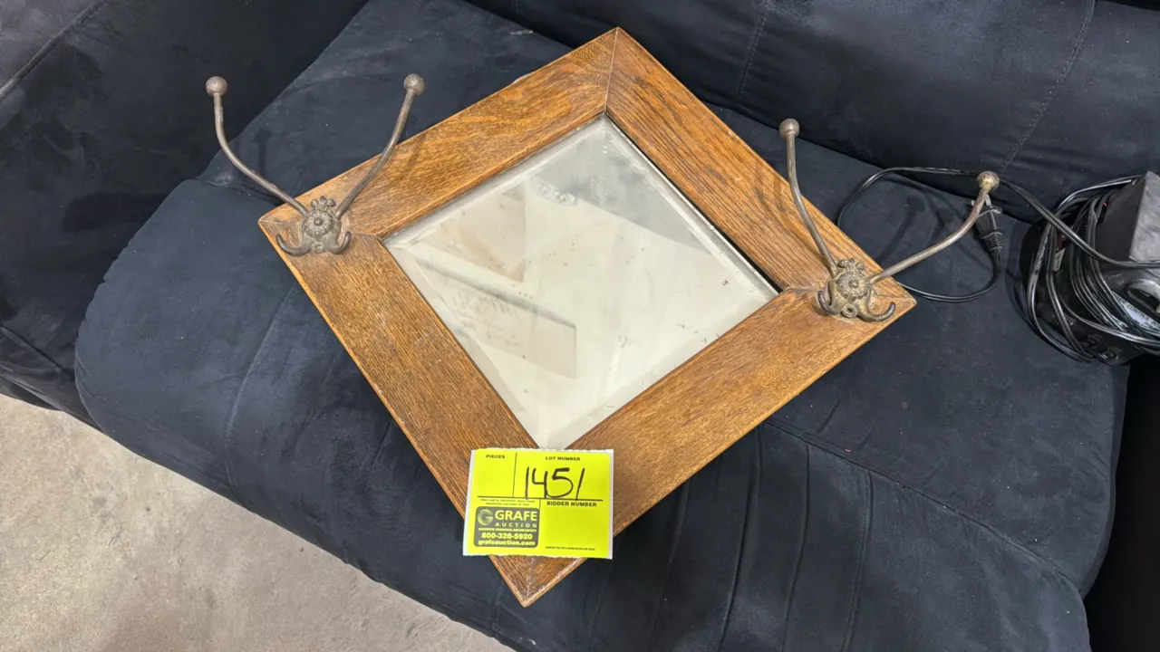 Vintage wood-framed wall mirror with brass hat and coat hooks. Features a square oak frame with beveled mirror glass and (2) decorative dual-arm brass