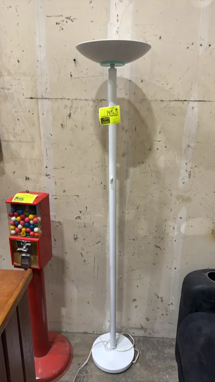 Metal torchiere floor lamp. Features a white finish, upturned bowl shade with halogen fixture and protective glass lens, and pole-mounted rotary dimme