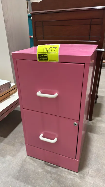 Metal 2-drawer file cabinet. Features pink finish, white pull handles, integrated lock on lower drawer, and hanging file rails.