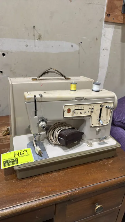 Singer Stylist Model 457 zig-zag sewing machine. Features adjustable stitch width, variable stitch length, multi-position needle settings, and integra