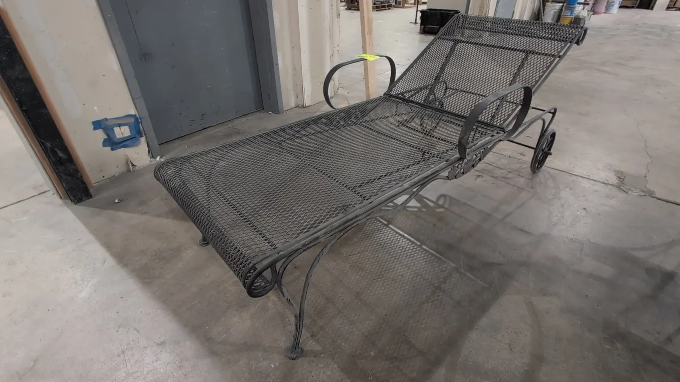 Metal patio chaise lounge chair. Features an expanded metal mesh surface, adjustable backrest, curved armrests, and decorative metal accents. 6'L. Mou