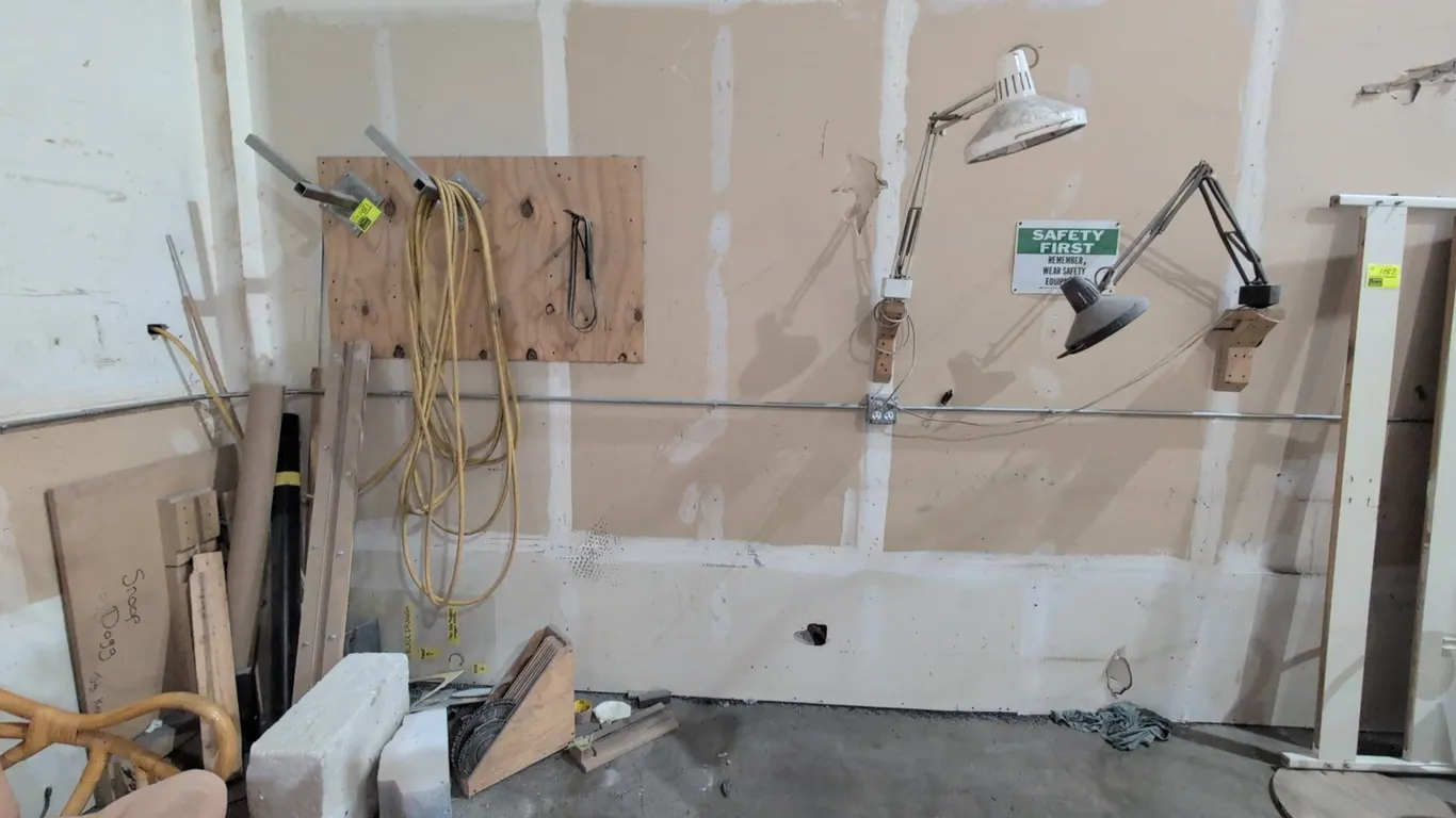 Shop fixtures and equipment assortment. Includes (2) wall-mounted articulated swing-arm task lights, wall storage brackets with hose, wall-mounted woo