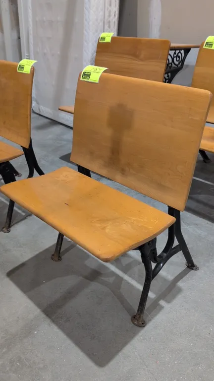 Vintage school seat. Features a curved wood backrest, folding wood seat, and painted cast metal frame with floor-mounting feet. 24"W.