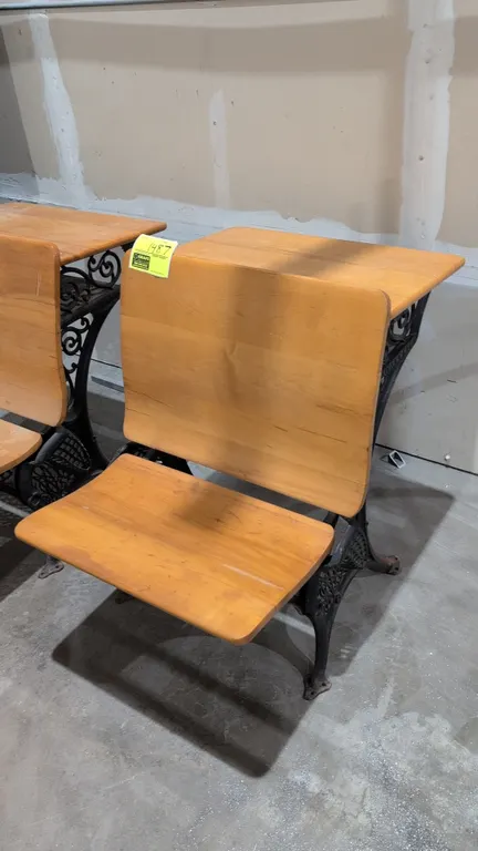 Vintage school desk. Features solid wood folding seat, integrated wood desktop, and ornate cast iron side frames with floor-mount feet. 24".