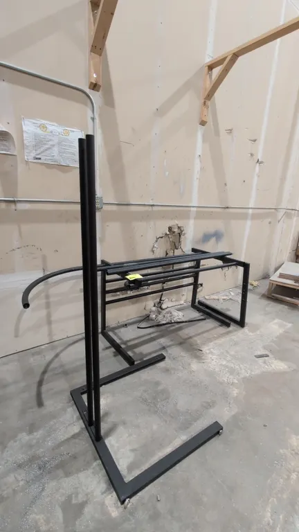 Metal desk with glass top. Features black metal frame construction and glass top panels. Note: Item is disassembled.