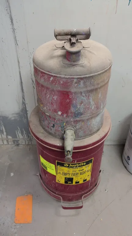 Justrite 10-gallon oily waste can. Features foot pedal lid operation and a raised, ventilated base. Includes a Justrite metal dispensing safety can wi
