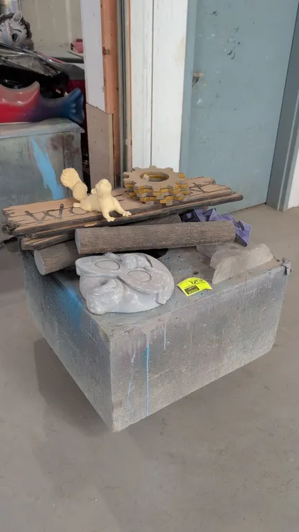 32" portable wood dolly with assorted cast resin statues and props. Includes a squirrel figurine, carved wood-style signage, stacked decorative gears,