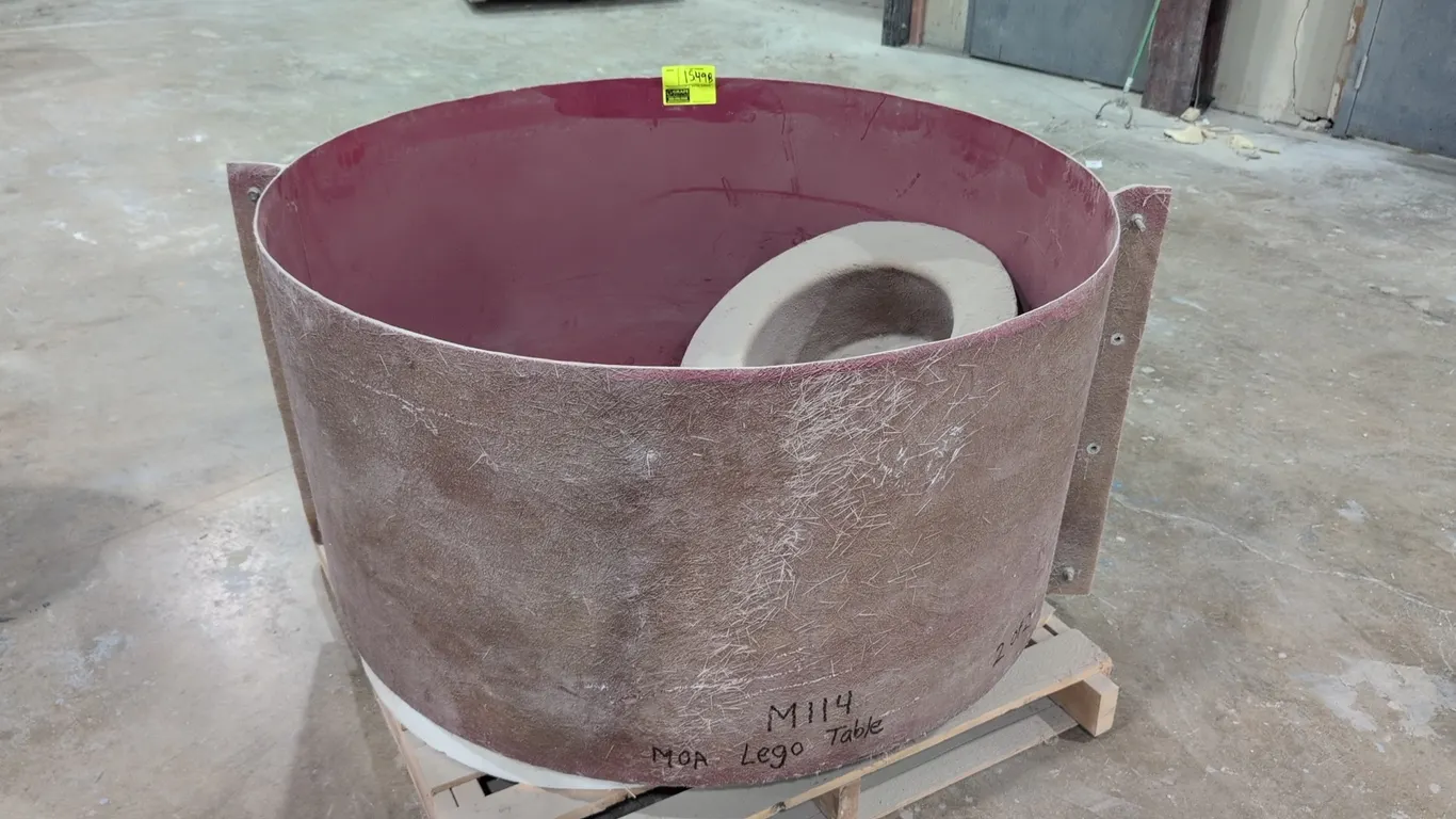 Poly round mold. Features fiberglass composite construction with smooth interior, bolted flange, and includes two circular insert molds. Marked 'M114