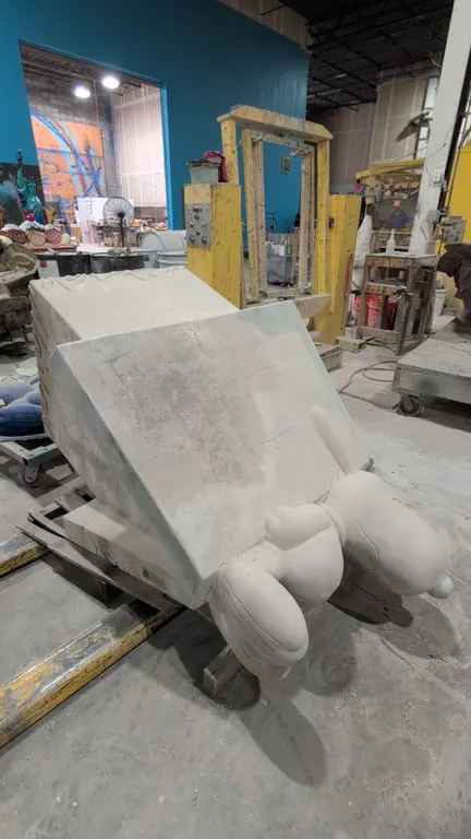 A Snoopy on Doghouse Display Statue. A large cast resin figure depicting Snoopy lying atop his doghouse. Features an unpainted primer finish and threa