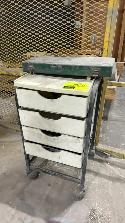 Portable storage cart with contents. Features a metal frame, 4 slide-out drawers, and an upper utility tray. Includes green lidded storage case and as