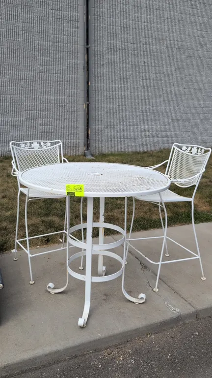 Metal patio table and (2) bar-height patio chairs. Features white painted finish, round expanded metal mesh tabletop with umbrella hole, and scroll fo