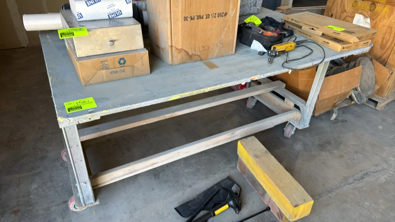 Custom built wood and metal portable workbench. Features painted wood work surface, metal leg frame, and lower wood cross bracing. Dimensions: 72" x 5