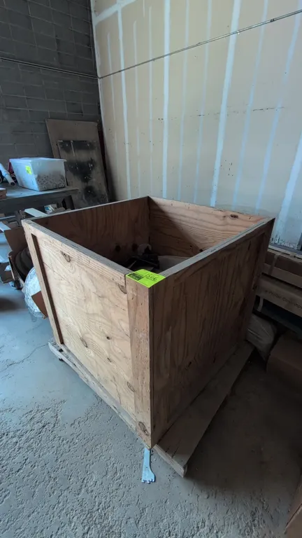 Wood shipping crate. Features plywood construction with solid wood framing and an open top. Dimensions: 39"L x 39"W x 37"H. Mounted on an integrated w